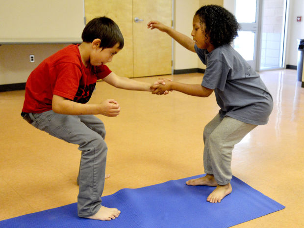 Kids build confidence at AcroYoga