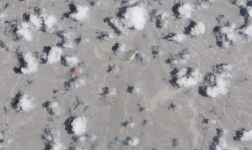 A satellite image of side-by-side ships at sea, off the coast of Fujairah