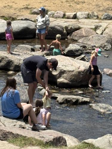 kids and parents splashing in the Blue River in downtown Breckenridge, Colorado