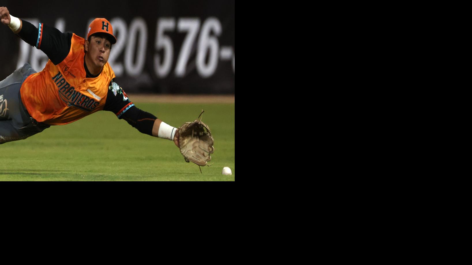 Portrait Of Hispanic Baseball Players With Gloves In Dugout Stock