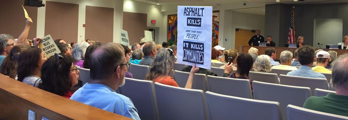 Signs from Broadway project opponents at Tucson City Council