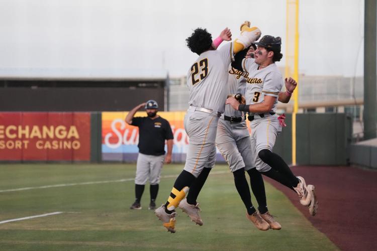 Saguaro Sabercats Alain Gomez-Gudino (23) celebrates his 2-run home run with teammate Davis Diller (3) as they take on the ALA Gilbert North Eagles during their 4A baseball championship game on May 18, 2026, at Tempe Diablo Stadium.