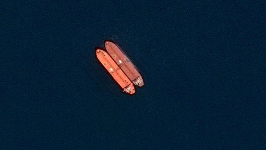 A satellite image of side-by-side ships at sea, off the coast of Sohar