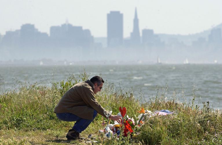 Michael Accurso of El Sobrante, California, pours water on some flowers at a memorial that includes flowers, candles and stuffed toys on April 19, 2003, in Richmond, California. The makeshift memorial is the location where the body of Laci Peterson and the fetus of her unborn child, Connor, were found. Scott Peterson, Laci Peterson's husband, has been arrested and...