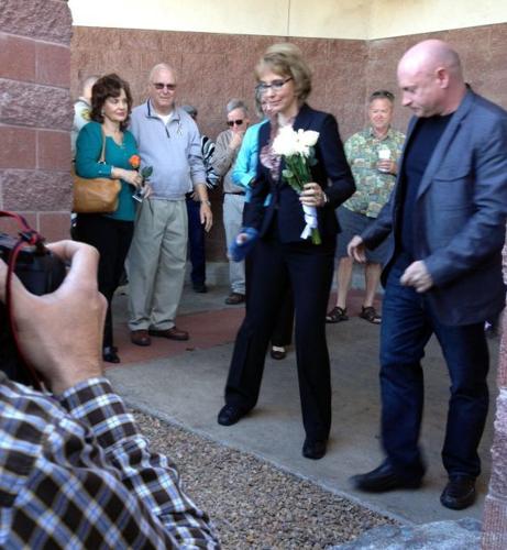 Giffords at Tucson shooting site: Expand gun-buyer background checks