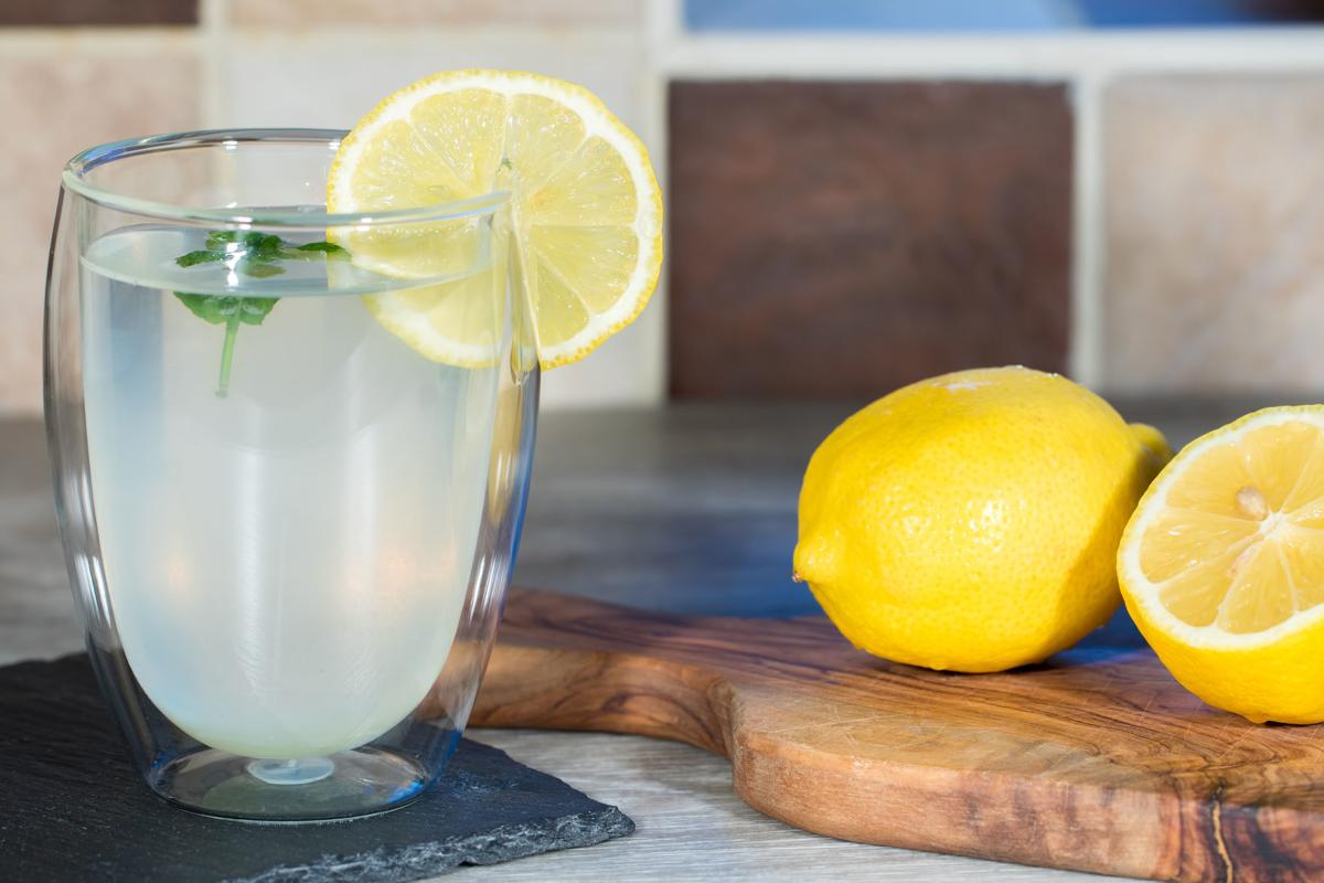 Home made lemonade. Refreshing glass of water with lemon
