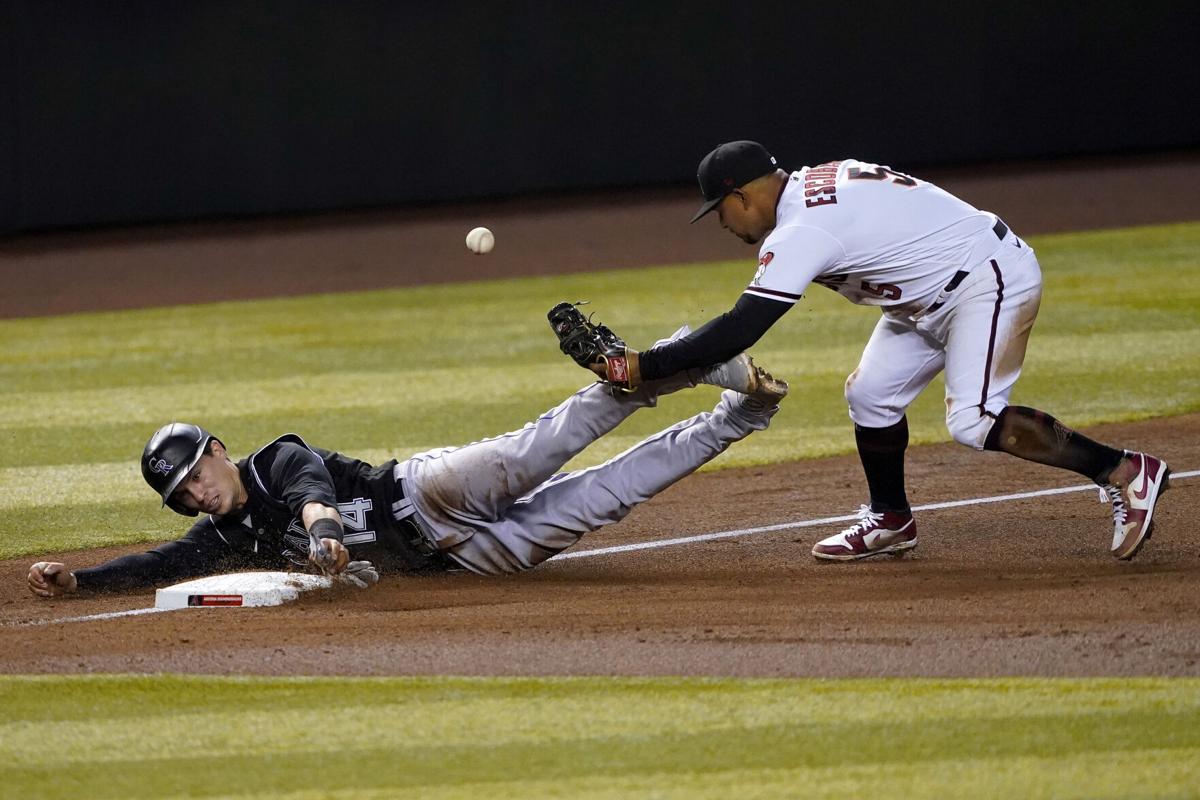 Raimel Tapia of the Colorado Rockies loses his helmet while