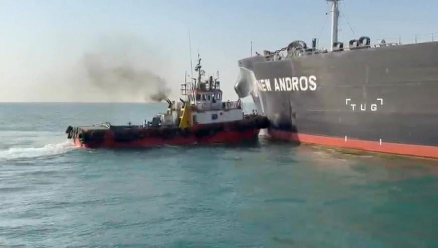 Water is sprayed on oil tanker New Andros, at Sea