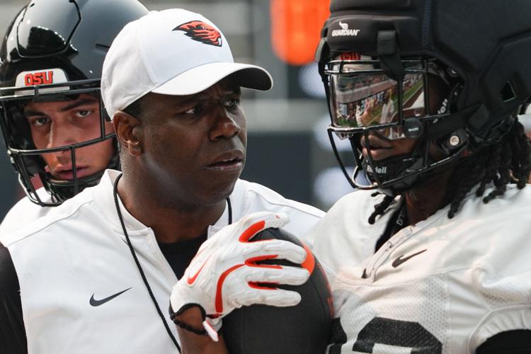 Oregon State head coach JaMarcus Shephard, left, talks to AJ Newberry during fall camp at Reser Stadium on Wednesday, Aug. 5,