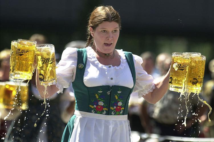CINCINNATI- SEPTEMBER 17: Annamarie Harten competes in a beer stein race as part of the Gemuetlichkeit Games held as a promotion for Oktoberfest Zinzinnati September 17, 2003 in Cincinnati. Competitors carry 6 beer 1- liter beer steins, which weigh about 30 pounds, a short distance and are penalized for spilled beer. Oktoberfest Zinzinnati is the nation's...