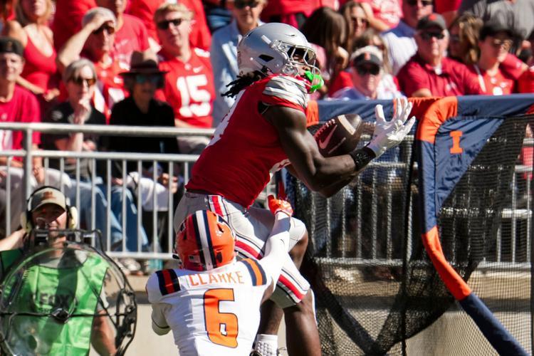 Ohio State Buckeyes wide receiver Jeremiah Smith (4) catches a pass over Illinois Fighting Illini defensive back Juice Clarke