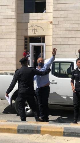 Cartoonist Emad Hajjaj being arrested