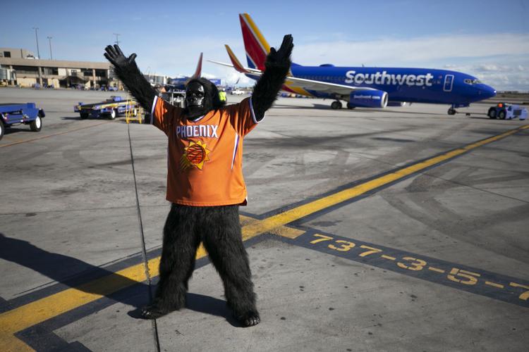 The Suns Gorilla fools around on the runway at Terminal 4 at Sky Harbor International Airport in Phoenix on Feb. 11, 2020. Suns players surprised Southwest Airlines passengers as they made boarding announcements, took boarding passes and even worked on the