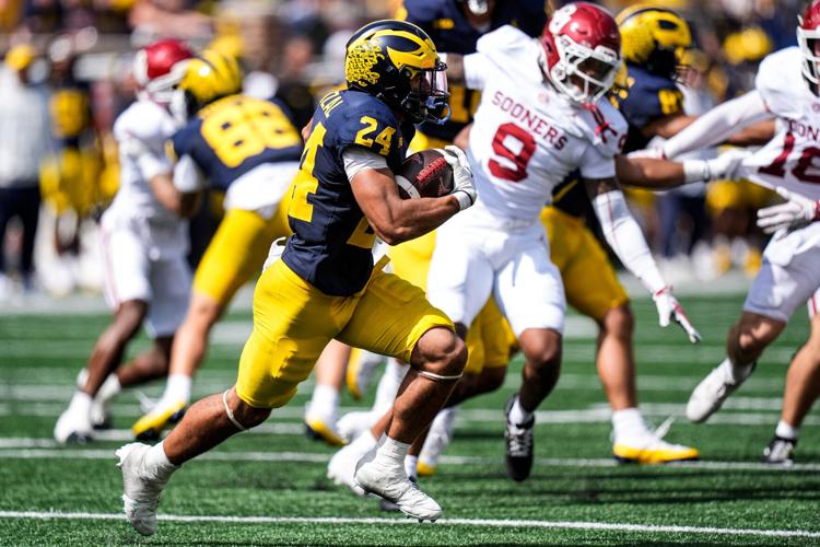 Michigan kick returner Bryson Kuzdzal runs against Oklahoma during the second half at Michigan Stadium in Ann Arbor on