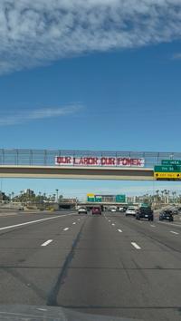 Giant Labor Day banners over I-10 call for social justice