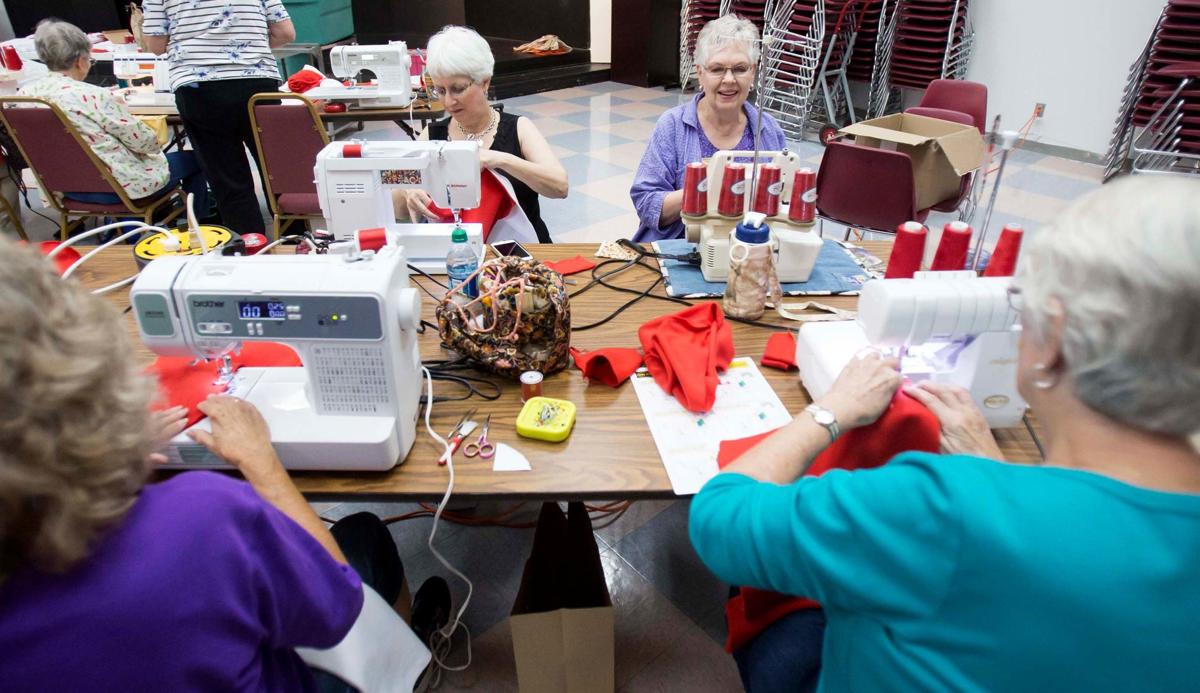 Sewing guild members help Tucson Medical Center dress babies for the