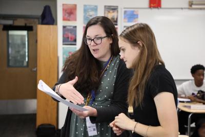 teacher explaining assignment to student