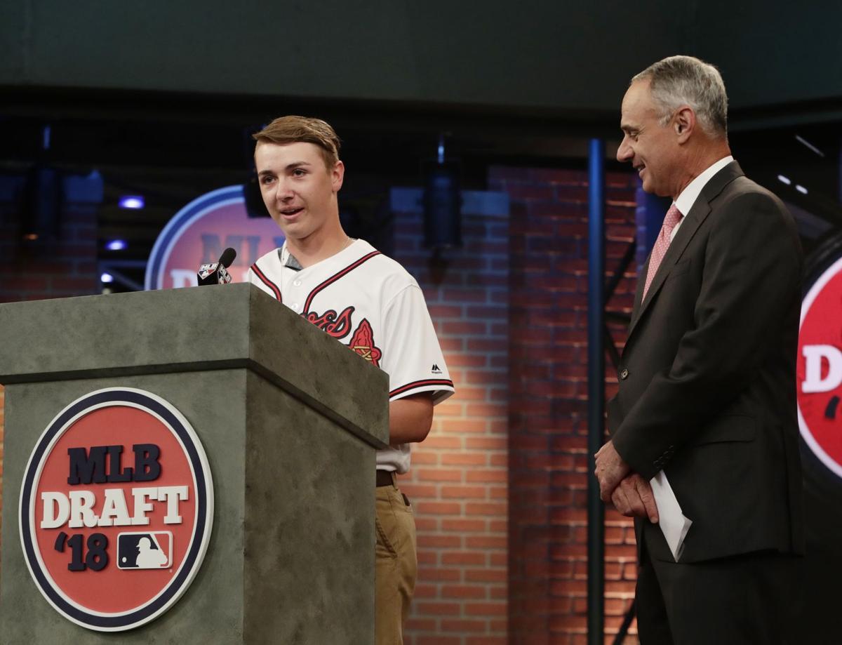 dale-murphy-of-the-atlanta-braves-sits-in-the-dugout-smiling-for