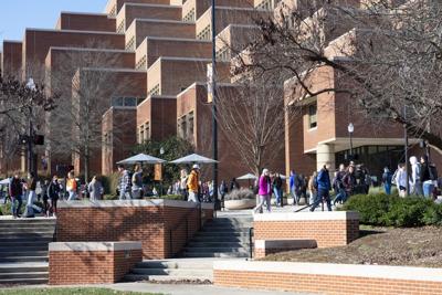 Students walk by Hodges Library
