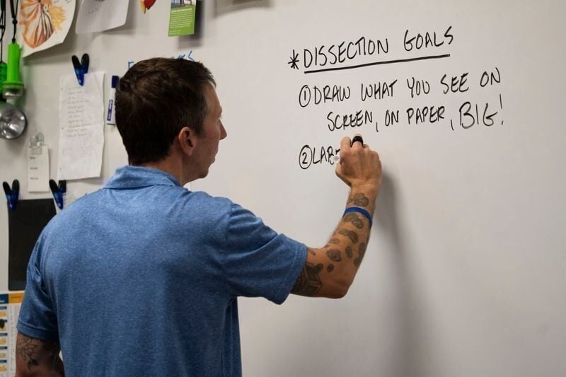 Gregory Barord writes on a dry erase board in his classroom at Central Campus on Tuesday, Oct. 8, 2024, in Des Moines.
