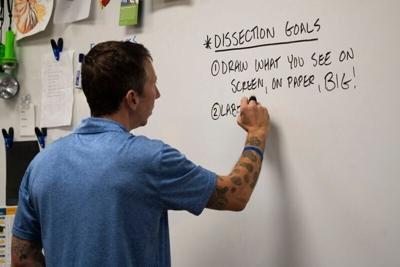 Gregory Barord writes on a dry erase board in his classroom at Central Campus on Tuesday, Oct. 8, 2024, in Des Moines.