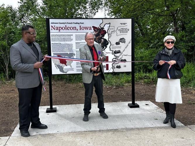 Iowa City mayor Bruce Teague (left), Chevalier David Markham, and Dr. Anna Barker (right) are pictured at a ribbon-cutting May 5 at Napoleon Park in Iowa City.