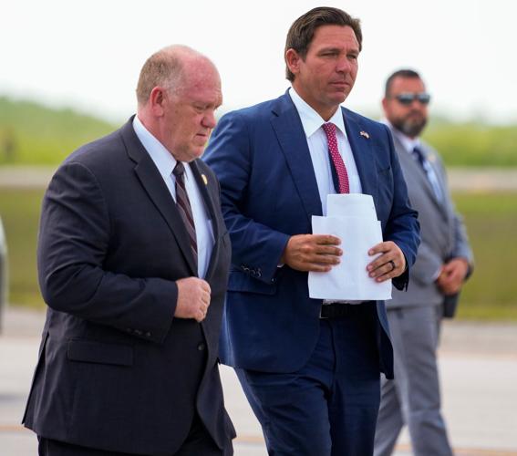 Governor Ron DeSantis walks with White House Border Czar Tom Homan as they hold a press conference at Alligator Alcatraz in