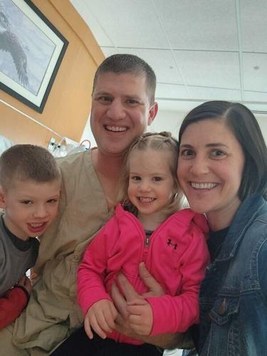 Jay Feldt, left, his wife, Gina, and their two children are pictured while he recovers at the Walter Reed National Military Medical Center after he was injured in the March 1 Iranian attack in Kuwait.
