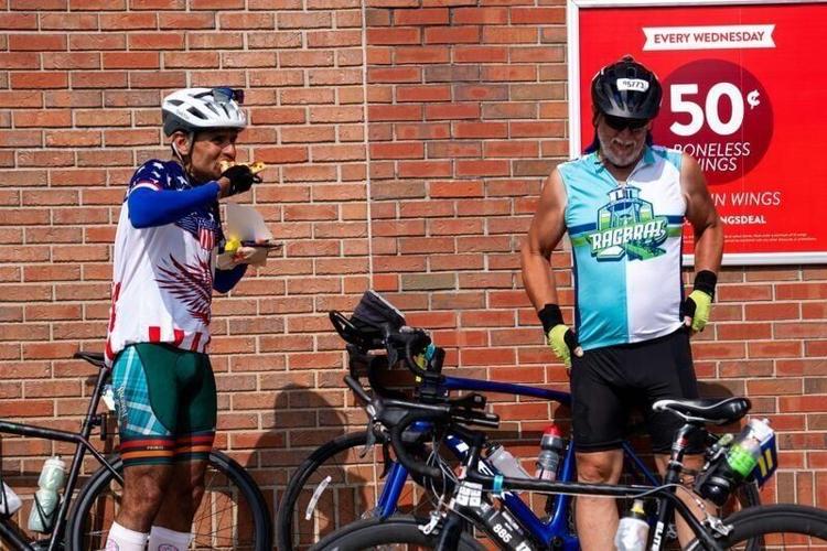 Abhay Rawal of Dubuque eats a slice of Casey’s breakfast pizza before attempting the America 250 double loop on Day 5 of RAGBRAI, Thursday, July 23, 2026, in Jesup.