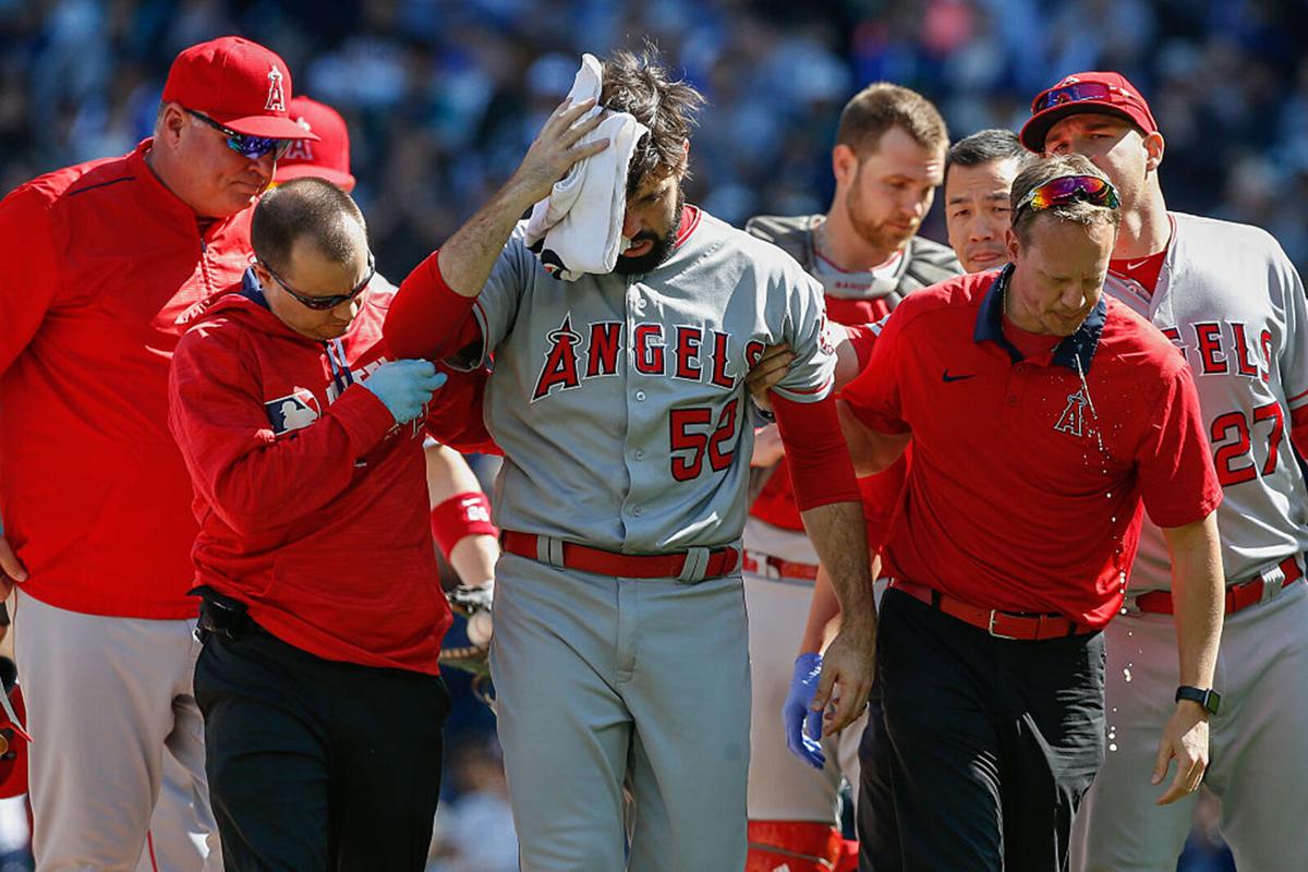 Starting pitcher Matt Shoemaker #52 of the Los Angeles Angels of Anaheim is helped off the field after being hit in the head with a batted ball off the bat of Kyle Seager of the Seattle Mariners in the second inning at Safeco Field on September 4, 2016 ...