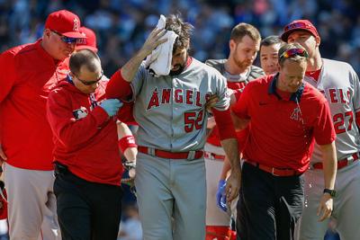 Starting pitcher Matt Shoemaker #52 of the Los Angeles Angels of Anaheim is helped off the field after being hit in the head with a batted ball off the bat of Kyle Seager of the Seattle Mariners in the second inning at Safeco Field on September 4, 2016 ...