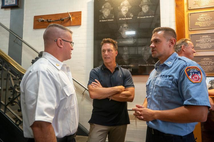 Retired New York Mets player Todd Zeile chats with New York firefighters during an annual event where retired players from the
