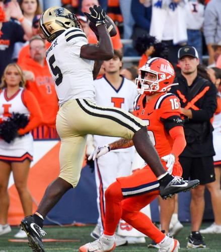 Oct 3, 2026; Champaign, Illinois, USA;  Purdue Boilermakers wide receiver Chauncey Magwood (5) makes a catch over Illinois Fighting Illini defensive back Tanner Heckel (16) during the second half at Gies Memorial Stadium.  Mandatory Credit: Ron Johnson-...