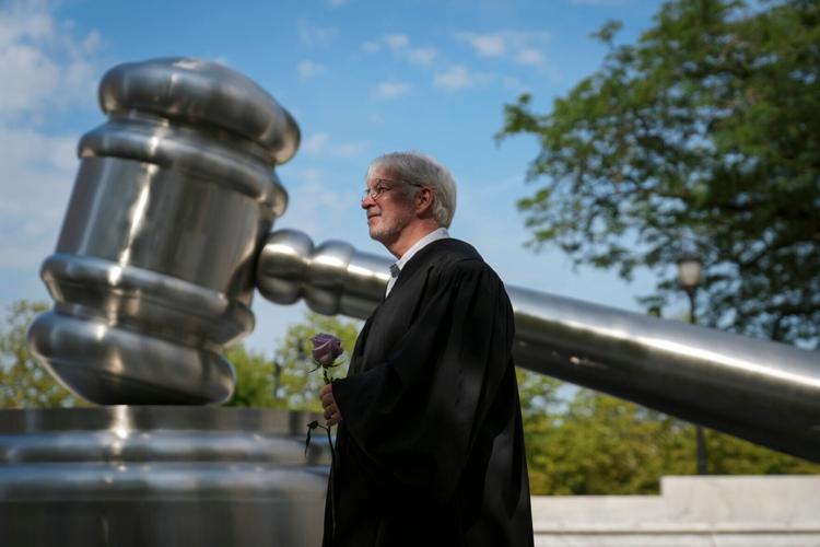As part of the Justice In Motion bus tour from Pennsylvania to Michigan, former Ohio Supreme Court Justice Michael Donnelly gathers with fellow judges outside the Ohio Supreme Court building during a stop in Columbus, Ohio on July 8, 2026. The civic engage