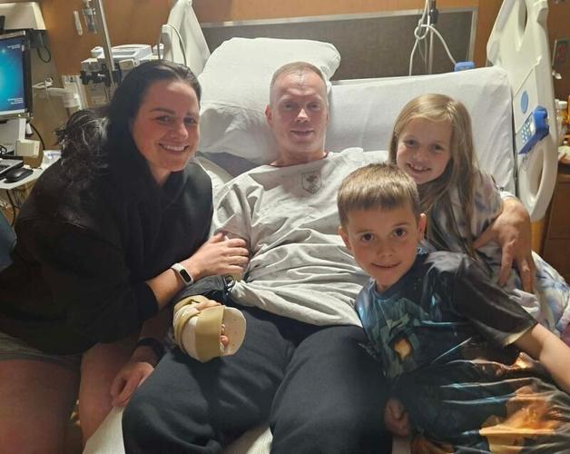 Tim Halbur, center, his wife, Holly, and their two children are pictured while he recovers at the Walter Reed National Military Medical Center after he was injured in the March 1 Iranian attack in Kuwait.