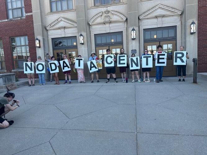 More than 100 protestors marched from Bandshell Park to Ames City Hall on Tuesday, July 14, as the City Council prepared to consider a proposed 100,000-square-foot data center at James Herman Banning Ames Municipal Airport.