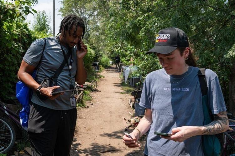 Street outreach worker Clifton Antoine, left, and community engagement coordinator Kate Schaechter conduct the annual Point-in-Time count at a homeless encampment on July 29, 2026, in Des Moines, Iowa. The federally required survey collects demographic ...