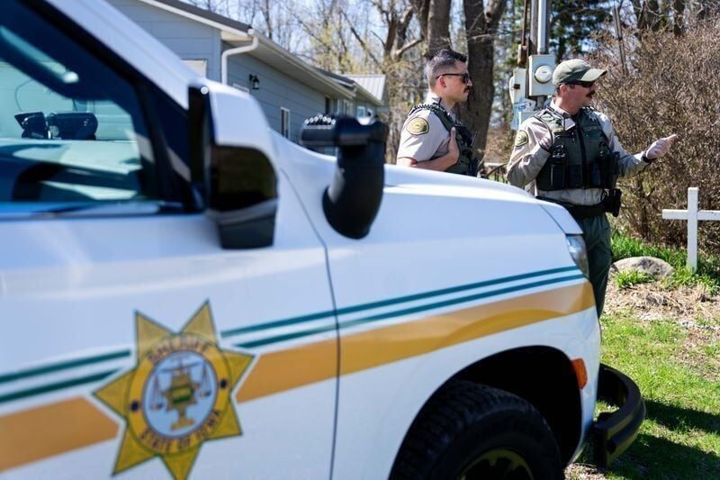Deputy TJ Merrifield (left) talks with his fellow Polk County Sheriff's Office deputy while responding to a call on April 10, 2026.