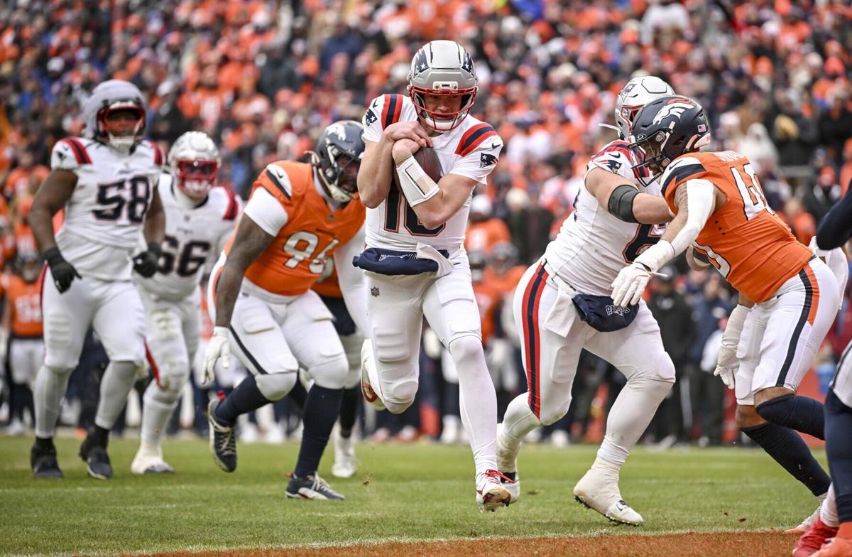 Drake Maye of the New England Patriots rushes in for a touchdown against the Denver Broncos during the second quarter at Empower Field at Mile High in Denver on Sunday, Jan. 25, 2026.