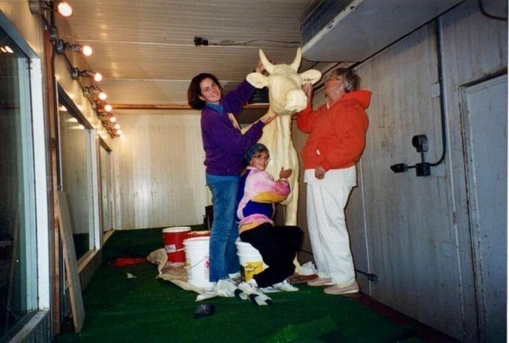 Sarah Pratt, left, sculpts the butter cow in 1998 with Norma "Duffy' Lyon, wearing red.