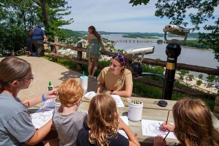 Kayleese Thoma, a summer naturalist with the Iowa DNR teaches kids about falcons at Bellevue State Park, June 15, 2026, in Bellevue, Iowa. The park is home to a successful population of nesting Peregrine Falcons, which nest on the limestone bluffs of th...