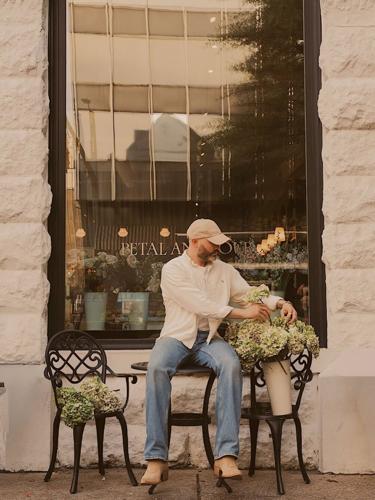 Owner Keegan Chitwood, sitting outside of Petal and Pour.