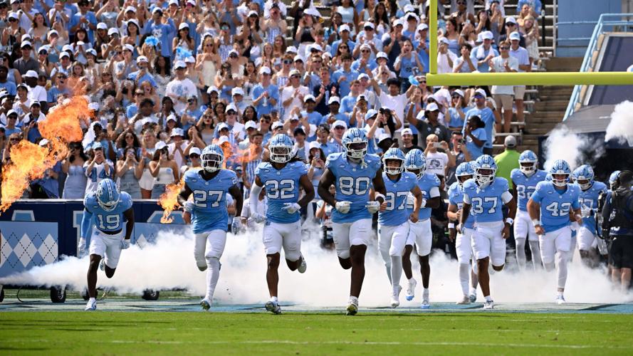 Sep 13, 2025; Chapel Hill, North Carolina, USA; North Carolina Tar Heels run on to the field before the game at Kenan Stadium. Mandatory Credit: Bob Donnan-Imagn Images