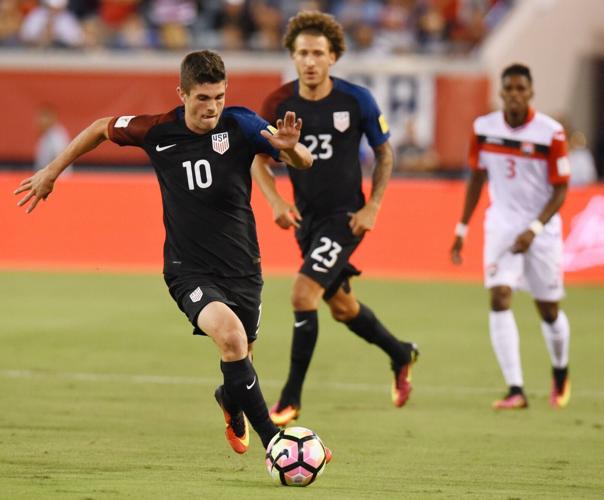 United States midfielder Christian Pulisic (10) moves the ball down the field during early game action against Trinidad &