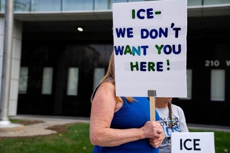 A small group of protesters gathers to rally against ICE in Iowa on Oct. 1, 2025, at the Neal Smith Federal Building in downtown Des Moines.