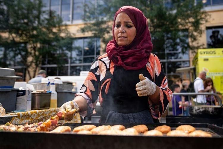 Lyela Ali of Lyela’s Kitchen works a grill during the World Food and Music Festival on Aug. 22, 2025, at Western Gateway Park in Des Moines, Iowa.