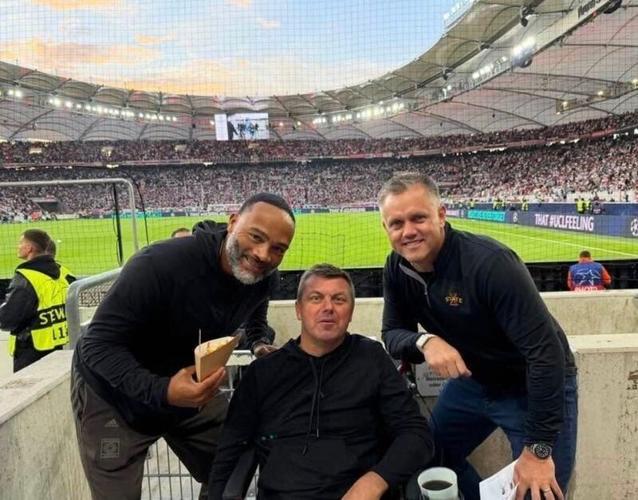 Former Iowa State football players, from left, Seneca Wallace, Jack Whitver and Lane Danielsen take in a soccer match in Germany.