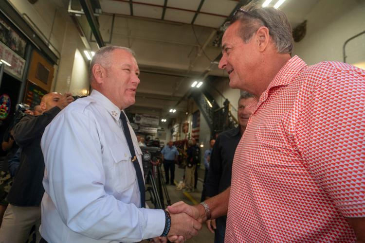 Chief of Fire Department John Esposito, left, shakes hands with retired New York Mets pitcher Al Leiter during an annual event