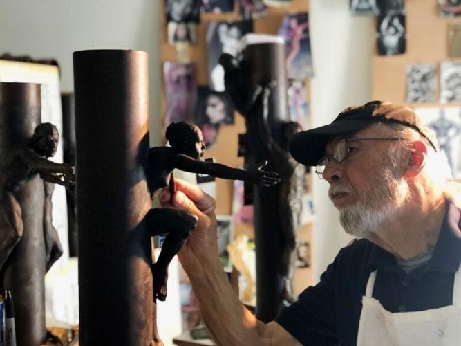 Tom Schomberg works in his studio on figures for his 9/11 series of sculptures.