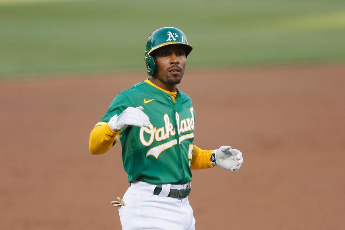 Tony Kemp of the Oakland Athletics reacts after hitting an RBI double before advancing to third base on a fielding error in the bottom of the third inning against the Los Angeles Angels at RingCentral Coliseum on Monday, June 14, 2021 in Oakland, California.